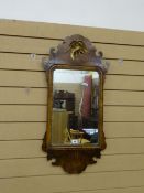 A Queen Anne style burr walnut and mahogany wall mirror with central rectangular mirror, carved