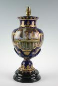 A reproduction German blue and gilt table lamp with oval plaque depicting ladies at rest, 17.5