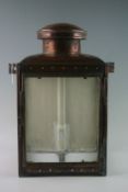 A late nineteenth century copper railway lantern with three glass panels and hinged door made for L.
