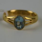 Edwardian gold (22ct) aquamarine single stone ring with oval mixed cut aquamarine in rub over