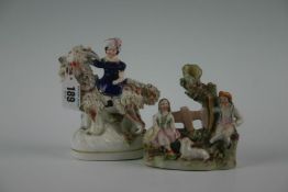 A 19th Century Staffordshire model of a young girl in cobalt blue dress seated upon a goat; and a