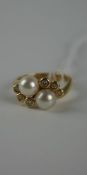 1980`s gold (14ct) cultured pearl and diamond crossover ring with two cultured pearls surrounded