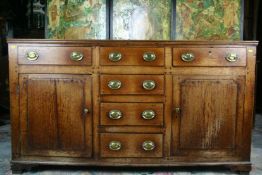 A late 18th/early 19th Century oak Welsh dresser base having four centre opening drawers with a