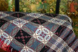 An early to mid 20th Century Welsh quilt of grey, blue and black geometrical design with red,