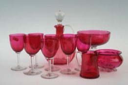 A group of Victorian cranberry glass ware comprising six wine glasses; decanter; jug; comport; and