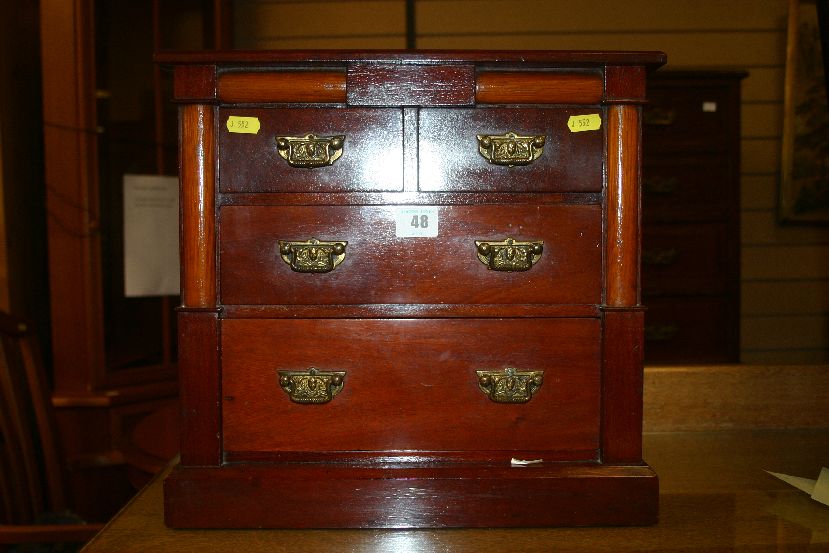 A mahogany apprentice chest in the Edwardian style of two long and two short drawers with brass drop