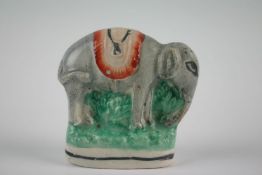 A rare 19th Century Staffordshire model of an Indian elephant with saddle cloth, 3 ins (7.5 cm) high