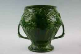 A Victorian green jardiniere depicting pond life with frog mask handles, fish, lily pads and