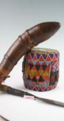 A large group of tribal items including a leather bound drinking vessel in the shape of a horn,