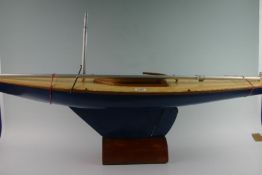 A five rater model yacht with blue painter hull, no rigging 39 ins long