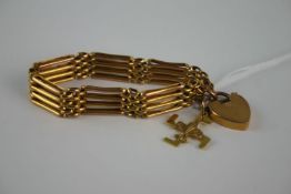 Late Victorian gold (9ct) gate link bracelet with gold (9ct) padlock clasp and a gold 9ct Boy