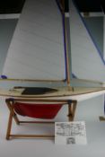 A pond yacht `RAINBOW` with white and red painted hull and ribbed sails 33ins long