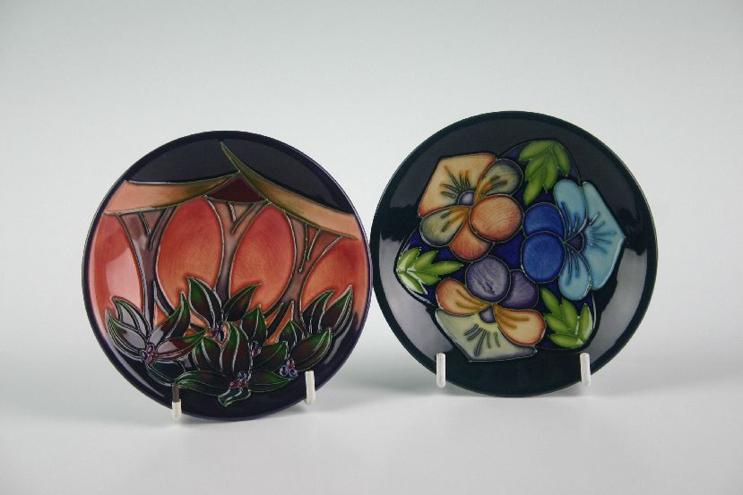 Two boxed contemporary Moorcroft dishes painted in various colours and with floral decoration