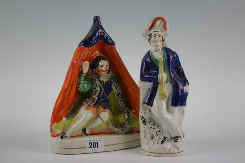 A 19th Century Staffordshire model of Charles I reclining on a day bed, 9.75 ins (25 cm) high; and