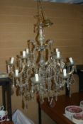 A late 19th Century drop lustre chandelier of twelve branches with later additions when converted