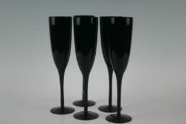 A set of five circa 1970s champagne flutes of maroon colour, 10 ins (25.5 cms) high