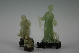 A collection of Oriental jade figures including an elegant lady with fan and flora at feet, a