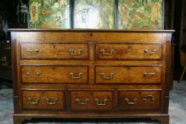 A late 18th/early 19th Century oak and crossbanded Lancashire style chest having a hinged top lid