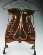 An art nouveau copper fire screen of naturalistic design 33ins high