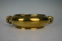 A polished bronze Chinese twin handled censer believed to be eighteenth century, possibly earlier