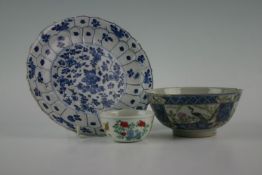 A Chinese porcelain footed bowl decorated with panels of wildlife, village scene, and courtesans;