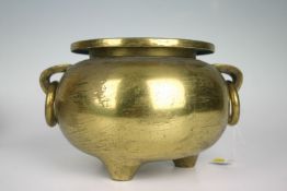 A late polished bronze twin and ring handled three footed Chinese censer (no character marks), (