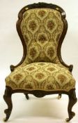 A Victorian nursing chair with floral tapestry fabric, with mahogany carved frame, interesting