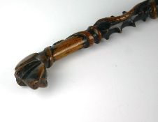 A late nineteenth century Irish thorn walking stick with stylized hound mask handle and serpent