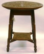 An early 20th Century oak circular occasional table with Celtic inspired carved decoration to top on
