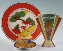 A collection of Clarice Cliff inspired china including vases, tea cups and saucers, plates, espresso