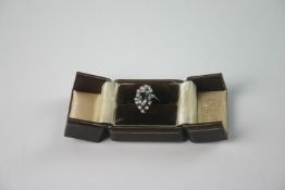 A ladies` white metal, diamond and blue stone cocktail ring with central mixed cut blue stone in