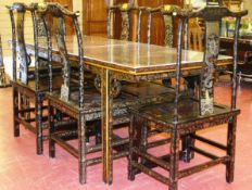 An early 20th Century Chinoiserie dining table and six chairs with gilt dragon and stylized floral