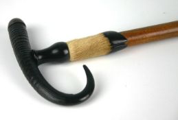 An early twentieth century hunting trophy walking stick with hoof collar and antler curved handle.