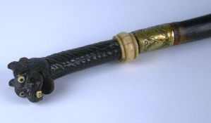 A nineteenth century horn, ivory and cane walking stick with carved horn handle in the form of an
