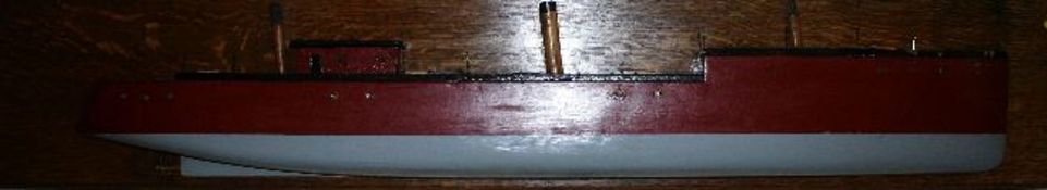 A model profile of a steamboat on oak plank mount, the bow painted red and blue and of large