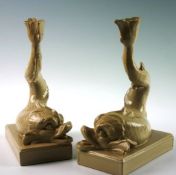 A pair of contemporary Wedgwood Drabware pottery candlesticks in the forms of mythical fish, 9.5 ins