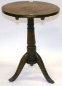A late 18th Century provincial oak wine table with circular top on tripod feet, 24 ins (61 cms)