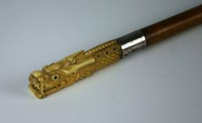 A late nineteenth century ivory, white metal and malacca walking stick with stiff carved dragon head
