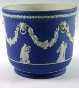 A Wedgwood Jasperware blue and white planter with lion ring mask floral garland and classical female