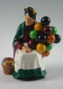 A Royal Doulton seated figure `The Old Balloon Seller` HN1315