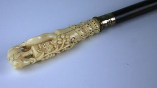 An early nineteenth century ivory, mahogany and white metal walking stick with tapering
