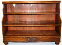 A late Victorian provincial mahogany waterfall bookcase with three tiers, two secret drawers to