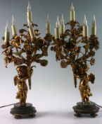 A pair of early 19th Century ormolu and marble cherubic table lamps, the winged and partially