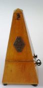 An early 20th Century metronome of usual form with squeezed octagonal plaque inscribed `METRONOME