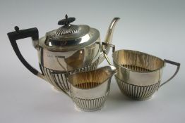 A three piece Edwardian silver tea service. Mark of Walker & Hall, Chester 1906. Comprising
