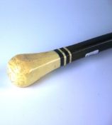 An early twentieth century ebony and ivory walking stick. The balloon shaped ivory handle with