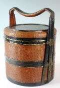 An Oriental rattan and lacquer circular rice caddy with circular japanned decorated top depicting