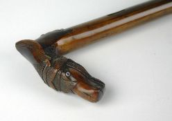 A late nineteenth / early twentieth century Russian walnut walking stick. The handle carved in the