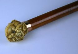 A late nineteenth century ivory and malacca walking stick. The ivory handle with carved