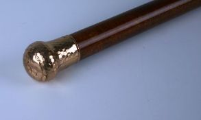 An Edwardian rose gold (9ct) mounted malacca walking stick. Mark of Dimier Brothers, London 1908.